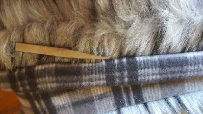 use tweezer to pick fur out from seam 